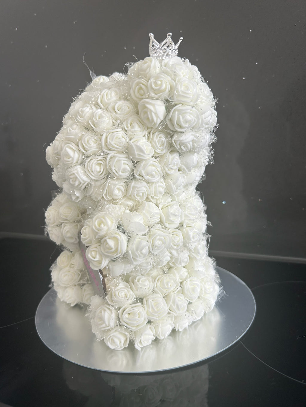 Hartes Handmade white rose teddy bear featuring foam roses, a sparkling crown, and a personalised heart plaque.