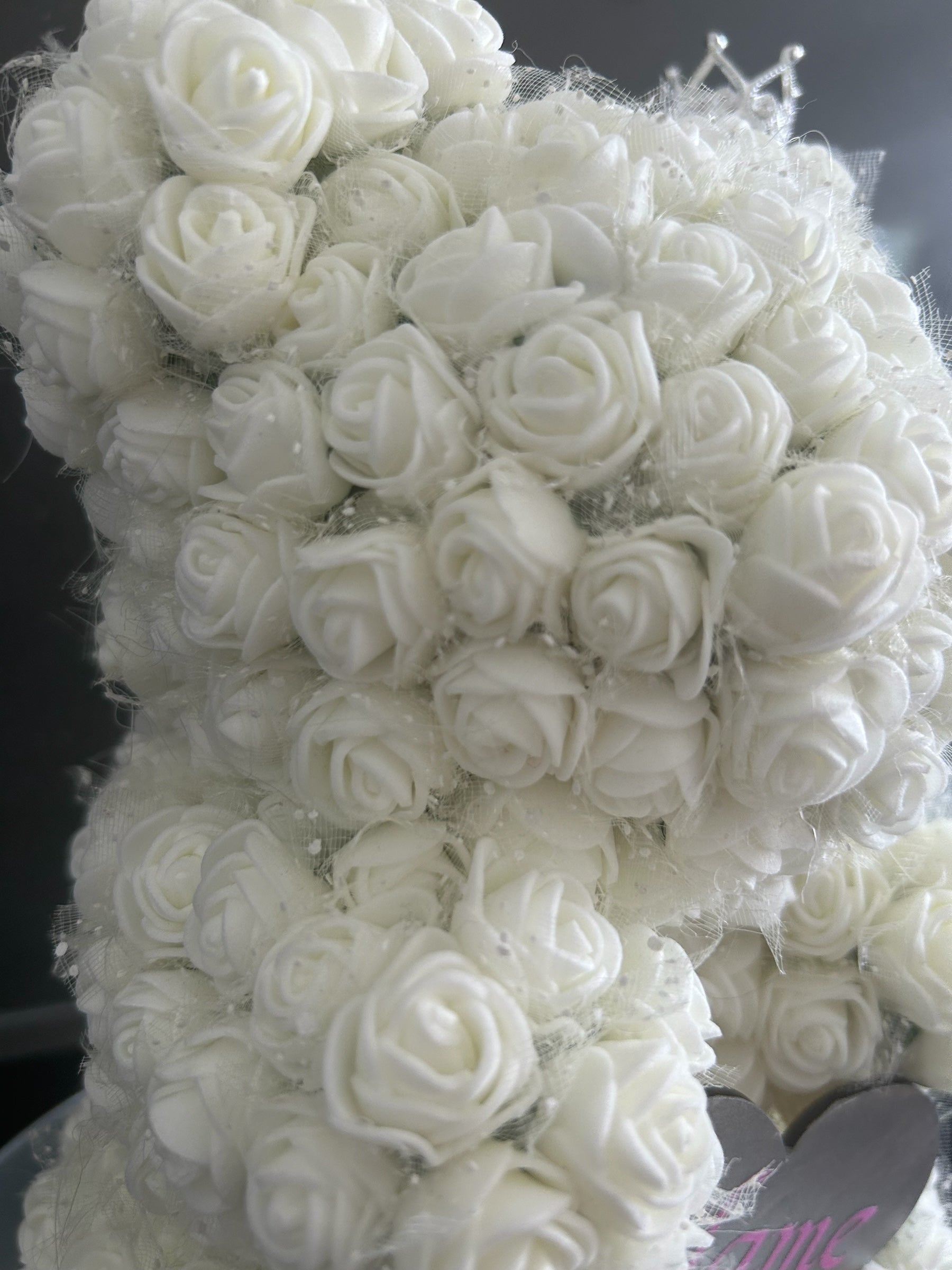 Hartes Handmade white rose teddy bear covered in foam roses with a sparkling crown and personalised heart plaque